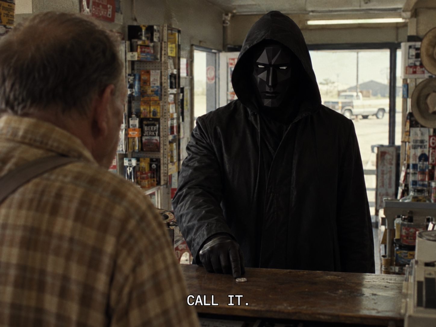 The N/A hooded figure placing a coin on a counter with the caption Call it