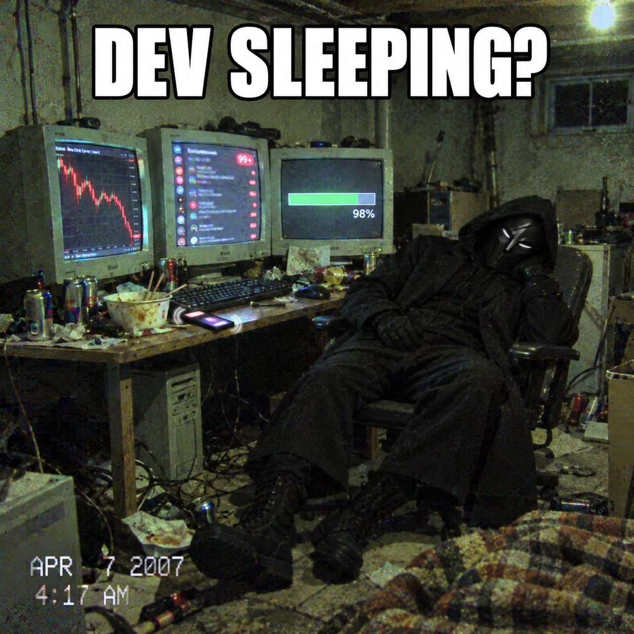 The N/A hooded developer asleep at a cluttered computer desk while the chart falls